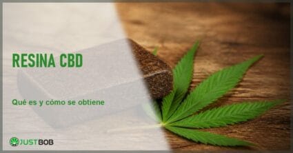 Bloque de resina de cáñamo CBD junto a una hoja de cáñamo sobre una mesa de madera, en alusión al hachís de cáñamo industrial